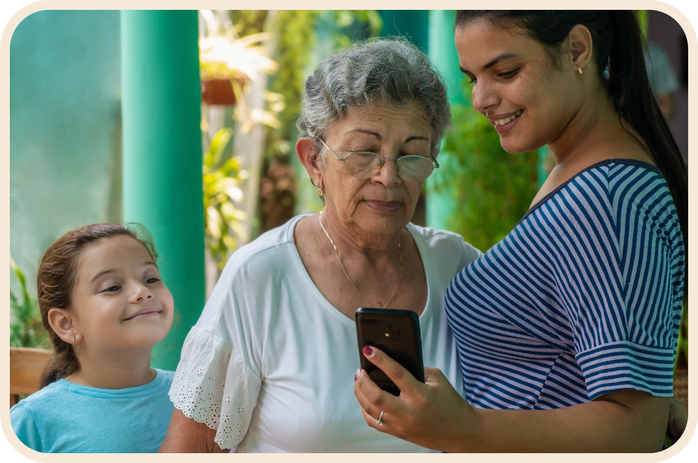 latino family looking at phone and smiling