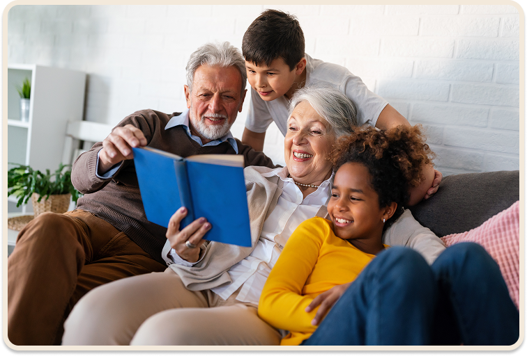 happy family sitting on a couch reading a book